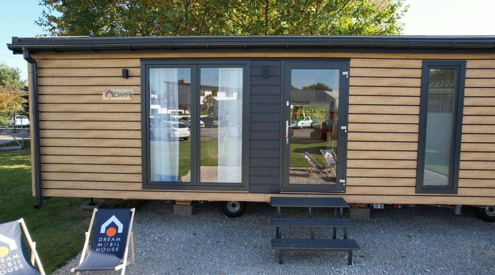 Tatradomy mobile home A — front façade with Scandinavian timber architecture and a glazed terrace